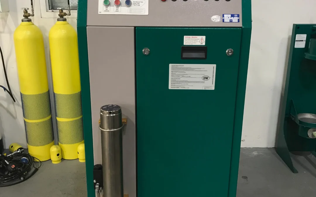 LW 320 ES high-pressure air compressor by Lenhardt & Wagner (L&W) in a workshop setting, showing control panel gauges, filtration housing, and yellow breathing-air storage cylinders in the background.
